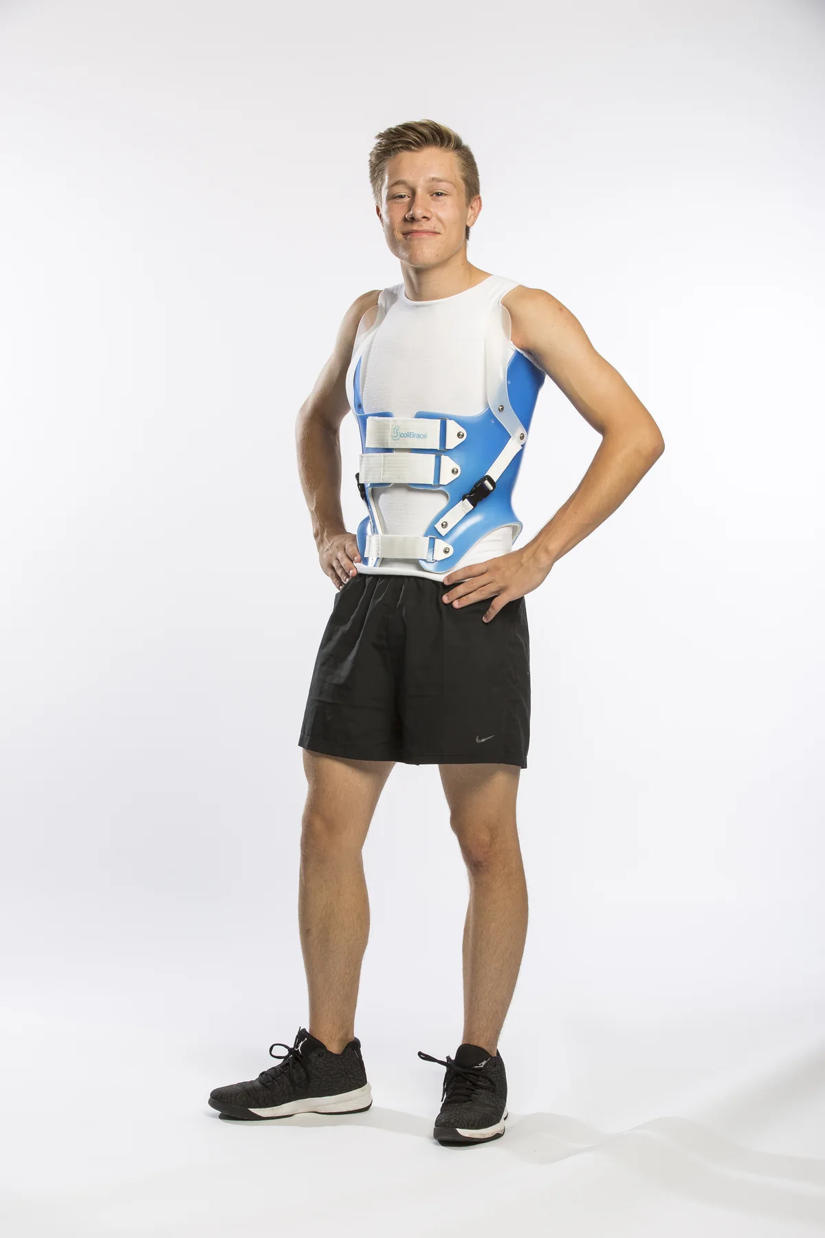 A young patient wearing a KyphoBrace for kyphosis