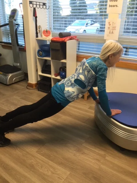 Guided exercise on the power plate at Spine and Scoliosis Clinic in Anacortes, WA